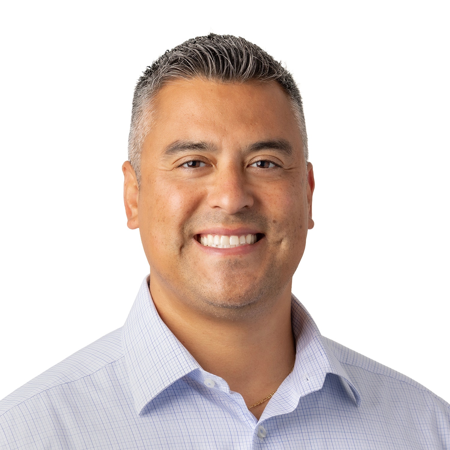 Smiling man, Andrew Jasso, with short dark hair in a light blue collared shirt against a plain white background.