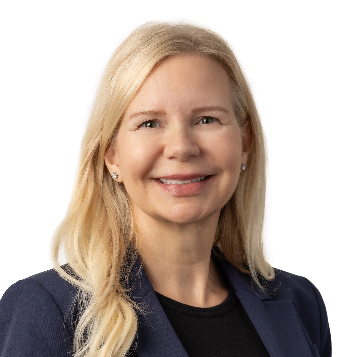 Smiling woman with long blonde hair, wearing a navy blazer and black top, in front of a white background.