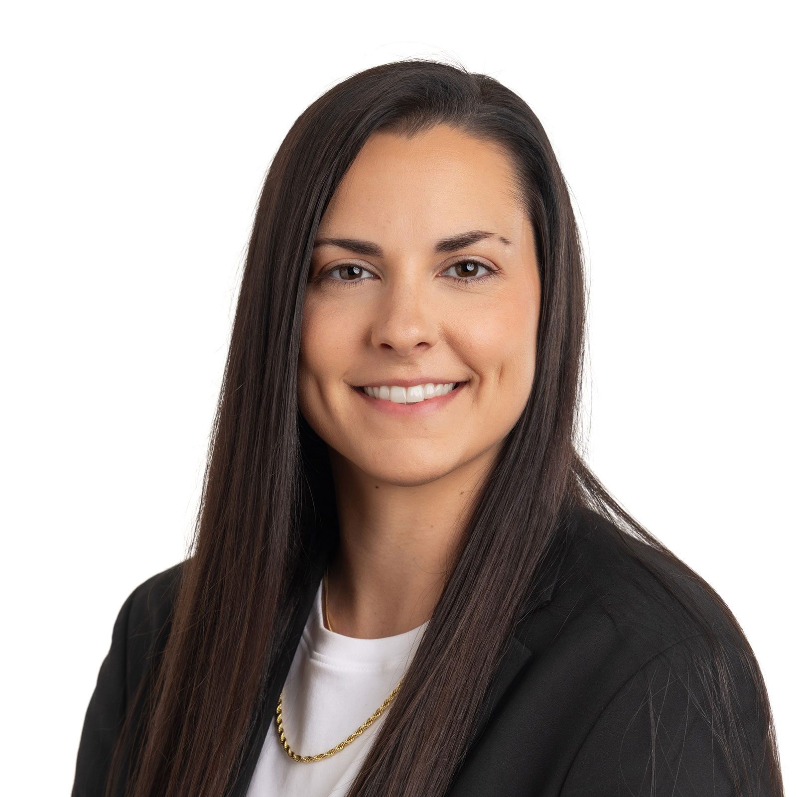 Woman named Kat Roan with long dark hair, wearing a black blazer, white top, and gold chain, smiling at the camera on a white background.